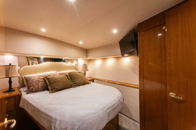 Wound Tight Yacht Photos Pics Luxurious bedroom interior of 2004 Viking 48 Convertible yacht with elegant lighting and decor.