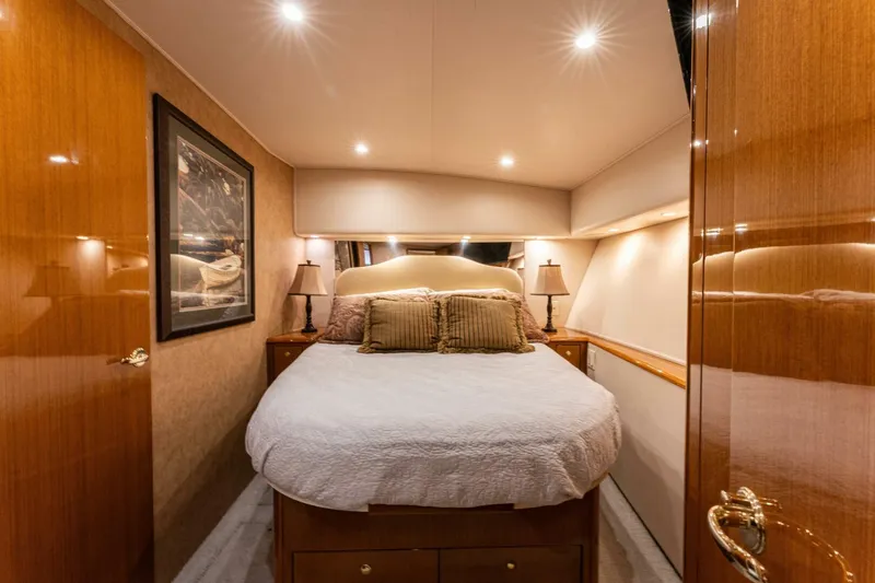 Wound Tight Yacht Photos Pics Luxurious bedroom interior of 2004 Viking 48 Convertible yacht with elegant wood finishes.