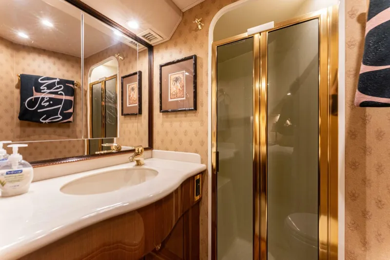 Wound Tight Yacht Photos Pics Luxurious bathroom in 2004 Viking 48 Convertible yacht with gold accents and elegant decor.