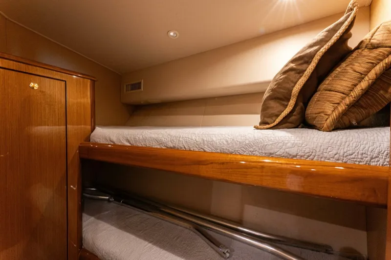 Wound Tight Yacht Photos Pics Bunk beds in 2004 Viking 48 Convertible yacht cabin with wooden finish and cozy pillows.