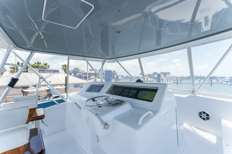 Wound Tight Yacht Photos Pics Helm of 2004 Viking 48 Convertible yacht with ocean view and modern controls.