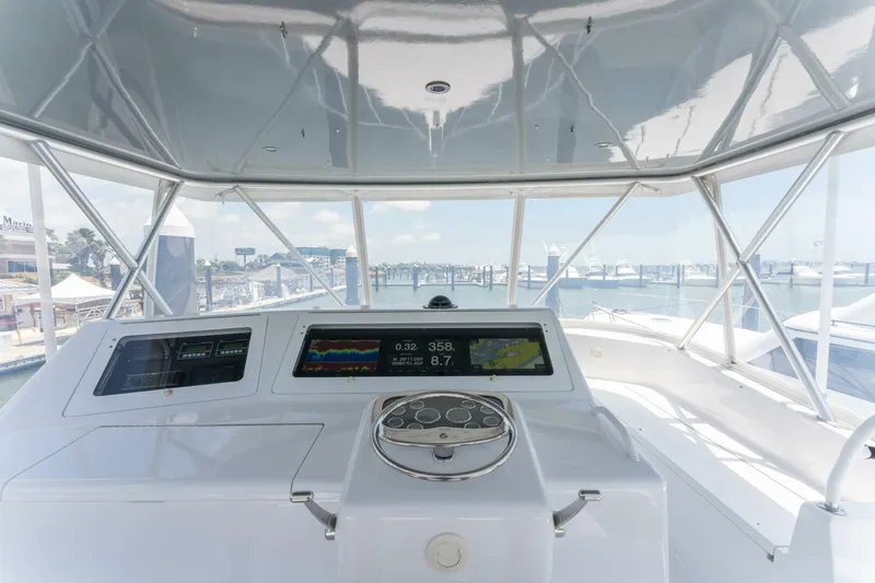Wound Tight Yacht Photos Pics Helm of 2004 Viking 48 Convertible yacht with navigation screens and marina view.