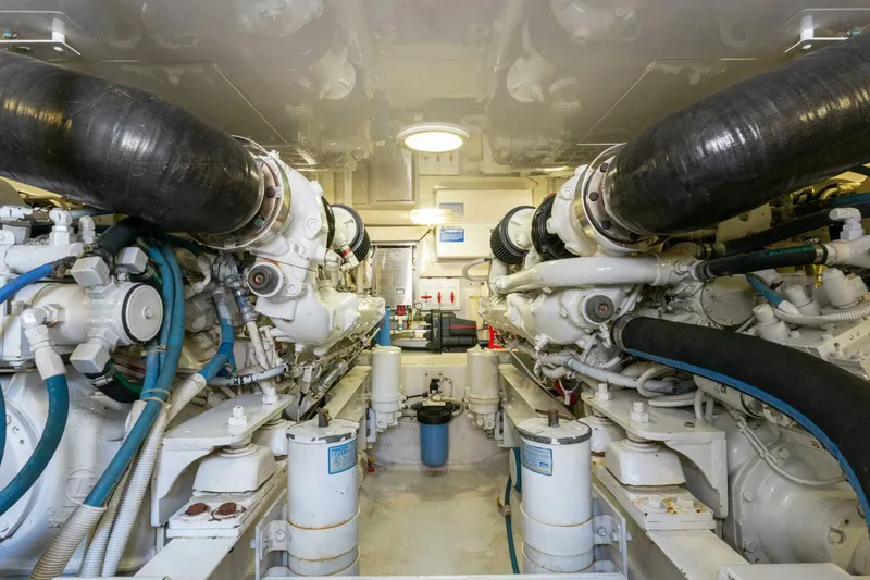 Wound Tight Yacht Photos Pics Engine room of a 2004 Viking 48 Convertible yacht, showcasing dual engines and mechanical components.
