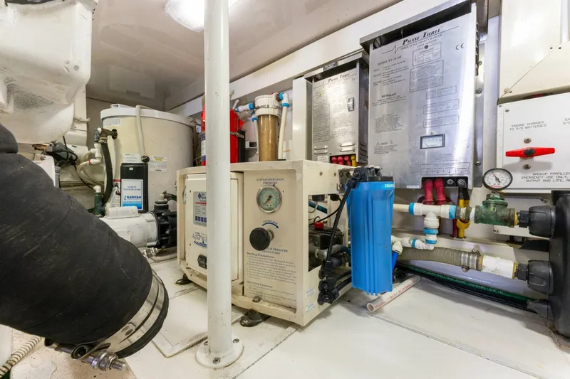 Wound Tight Yacht Photos Pics Engine room of 2004 Viking 48 Convertible yacht with various mechanical components and gauges.