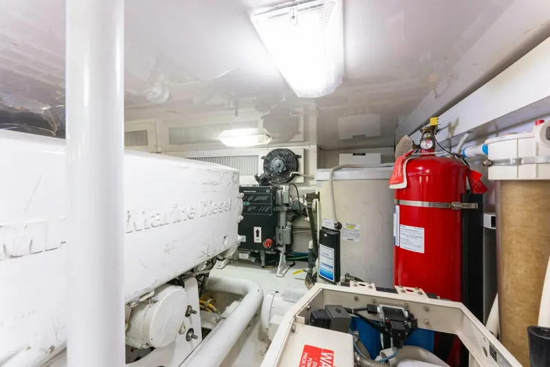 Wound Tight Yacht Photos Pics Engine room of 2004 Viking 48 Convertible yacht with marine diesel engine and fire extinguisher.