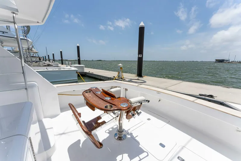 Wound Tight Yacht Photos Pics 2004 Viking 48 Convertible yacht docked, featuring a fishing chair and ocean view.