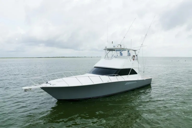 Wound Tight Yacht Photos Pics 2004 Viking 48 Convertible yacht on calm waters under cloudy skies.