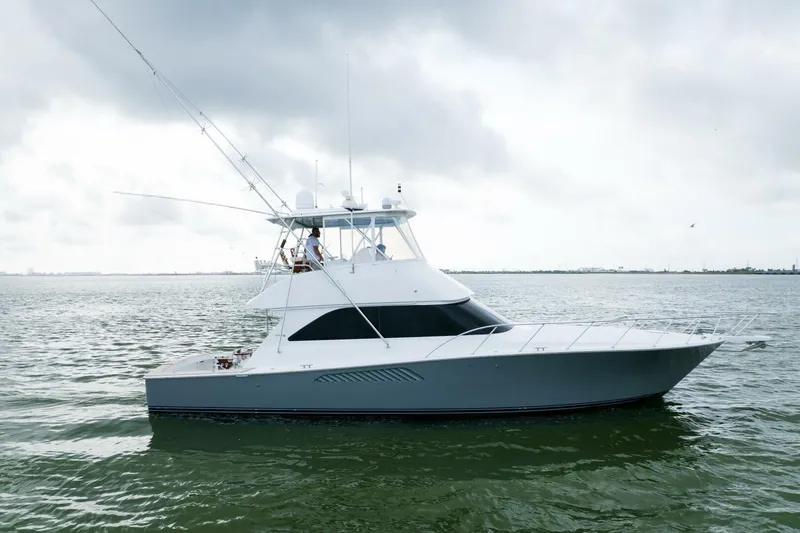 Wound Tight Yacht Photos Pics 2004 Viking 48 Convertible yacht on calm waters under cloudy skies.
