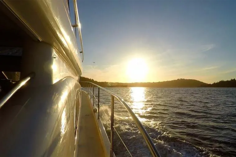 Jugni Yacht Photos Pics Sunset view from a 2003 Viking Princess 65 yacht cruising on the water.