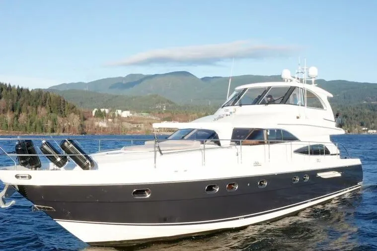Jugni Yacht Photos Pics Luxury 2003 Viking Princess 65 yacht cruising on scenic waters with mountainous backdrop.