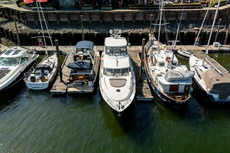 Jugni Yacht Photos Pics Docked boats including a 2003 Viking Princess 65 yacht at a marina.