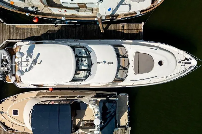Jugni Yacht Photos Pics Aerial view of a 2003 Viking Princess 65 yacht docked at a marina.