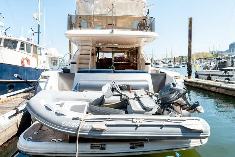 Jugni Yacht Photos Pics Luxury 2003 Viking Princess 65 yacht docked with inflatable boat on deck.