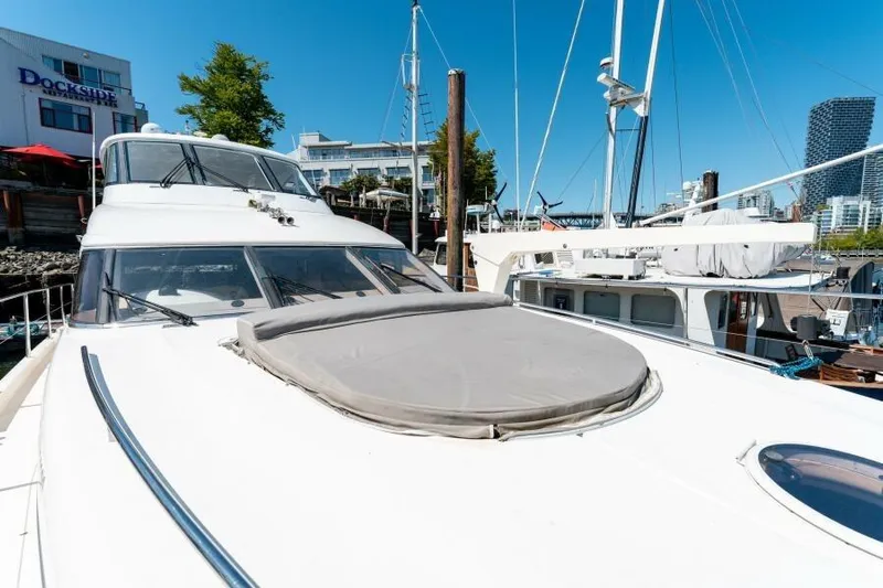 Jugni Yacht Photos Pics 2003 Viking Princess 65 yacht docked at marina, clear blue sky background.