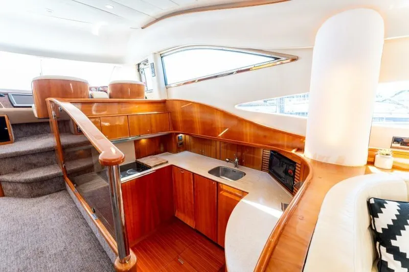 Jugni Yacht Photos Pics Luxurious interior of 2003 Viking Princess 65 yacht with elegant wood finishes and modern amenities.
