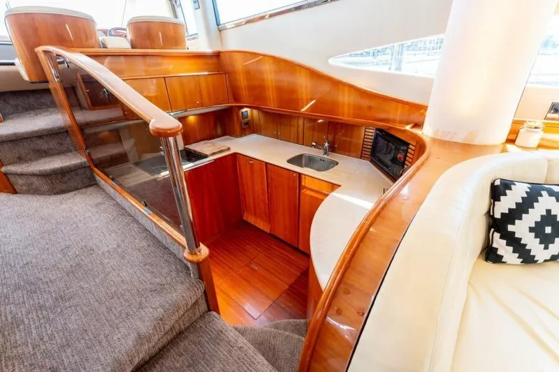 Jugni Yacht Photos Pics Luxurious 2003 Viking Princess 65 yacht interior with elegant wood finishes and modern kitchen amenities.