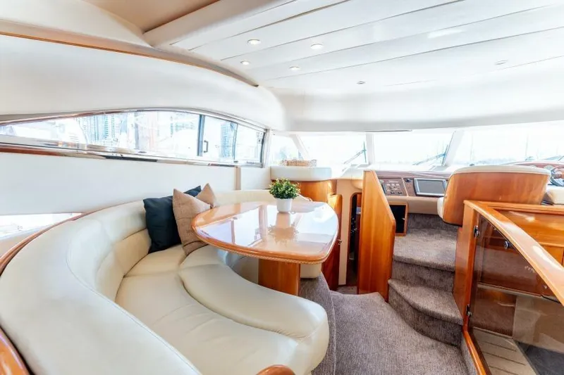 Jugni Yacht Photos Pics Luxurious interior of 2003 Viking Princess 65 yacht with elegant seating and wooden accents.