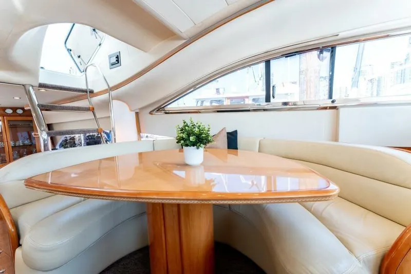 Jugni Yacht Photos Pics Luxurious interior of 2003 Viking Princess 65 yacht with elegant seating and table.