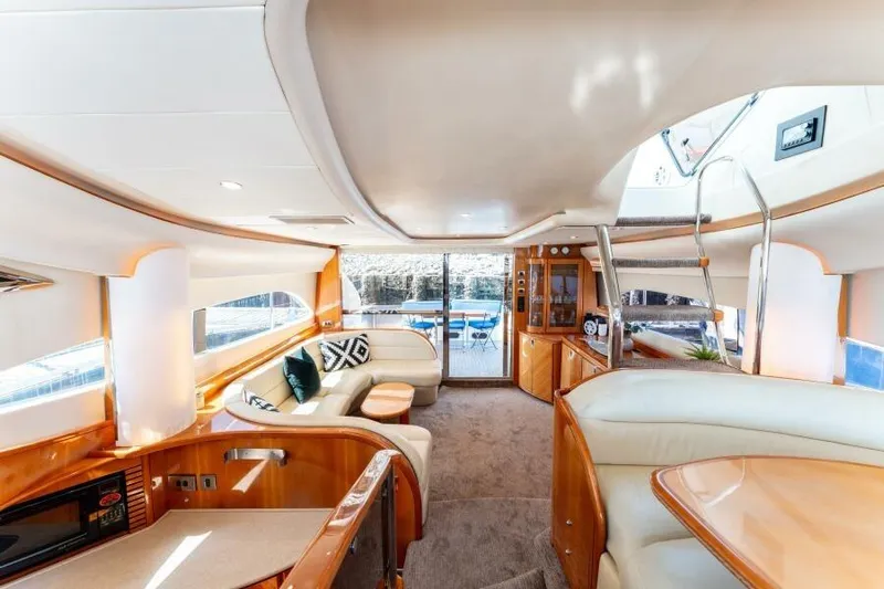 Jugni Yacht Photos Pics Luxurious interior of 2003 Viking Princess 65 yacht with elegant seating and modern design.
