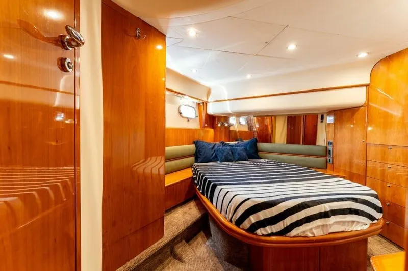 Jugni Yacht Photos Pics Luxurious cabin interior of 2003 Viking Princess 65 yacht with striped bedding.