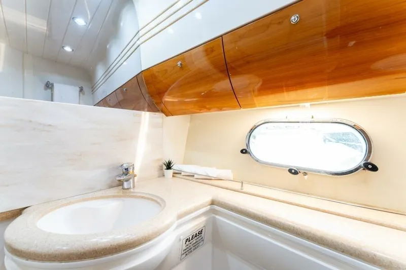 Jugni Yacht Photos Pics Luxurious bathroom interior of 2003 Viking Princess 65 yacht with elegant wood accents.