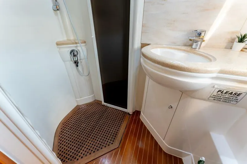 Jugni Yacht Photos Pics Luxurious bathroom in 2003 Viking Princess 65 yacht with modern sink and shower.