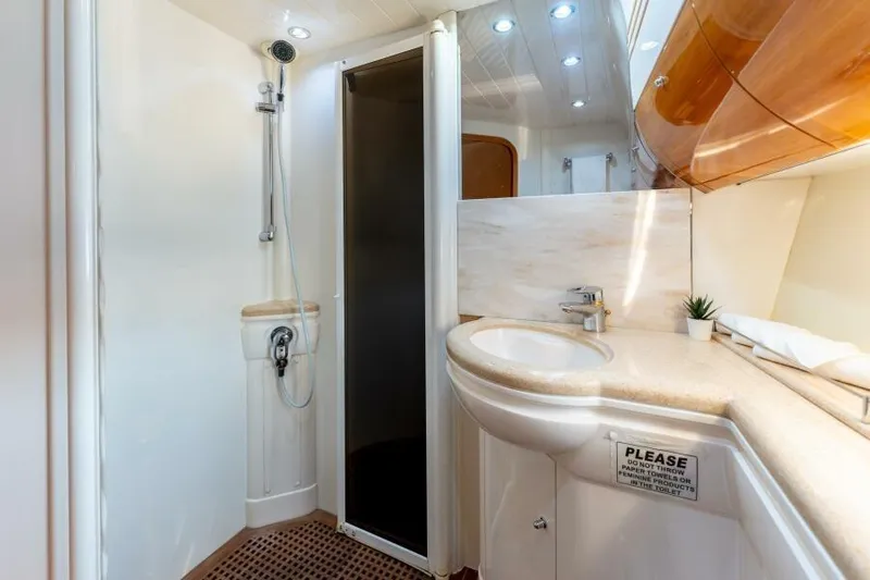 Jugni Yacht Photos Pics Luxurious bathroom in 2003 Viking Princess 65 yacht with modern fixtures and elegant design.