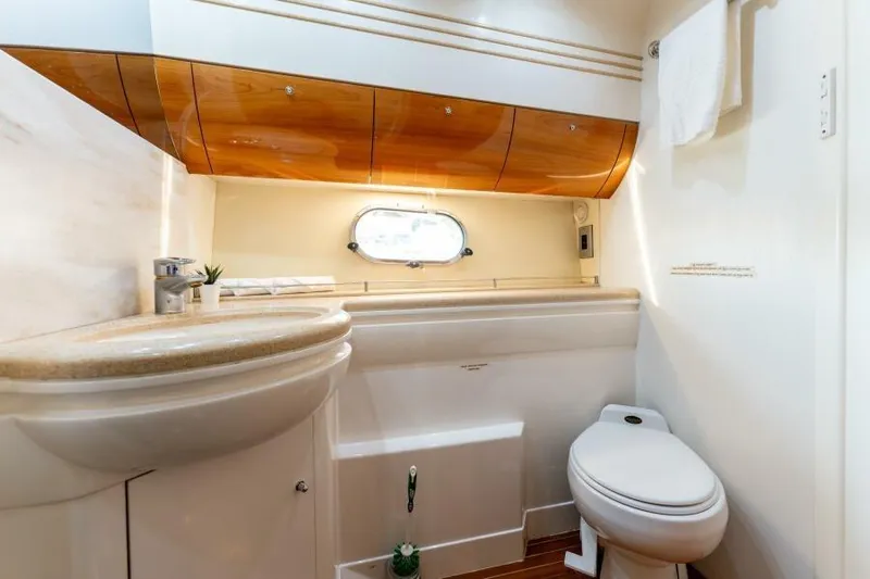 Jugni Yacht Photos Pics Luxurious bathroom in 2003 Viking Princess 65 yacht with elegant wood accents.
