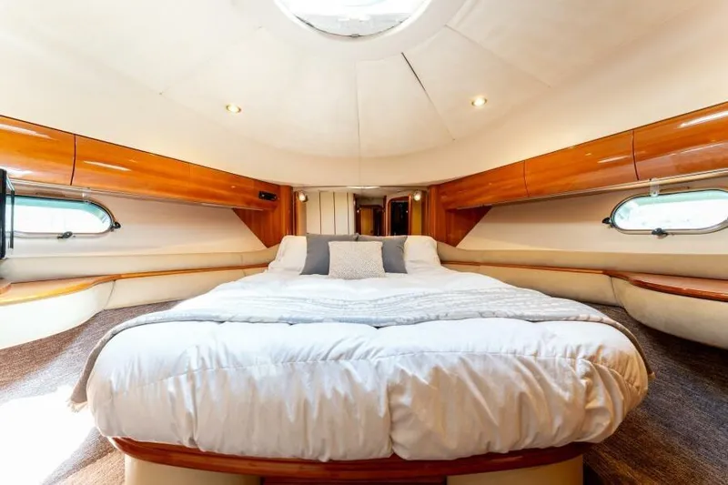 Jugni Yacht Photos Pics Luxurious bedroom interior of 2003 Viking Princess 65 yacht with elegant wood finishes.