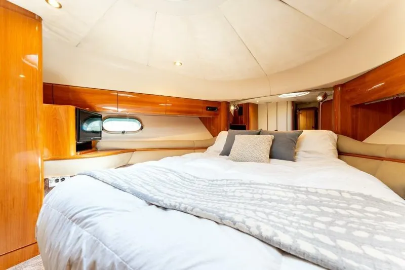 Jugni Yacht Photos Pics Luxurious bedroom interior of 2003 Viking Princess 65 yacht with elegant wood finishes.