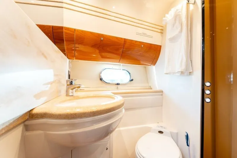 Jugni Yacht Photos Pics Luxurious bathroom in 2003 Viking Princess 65 yacht with elegant wood accents.