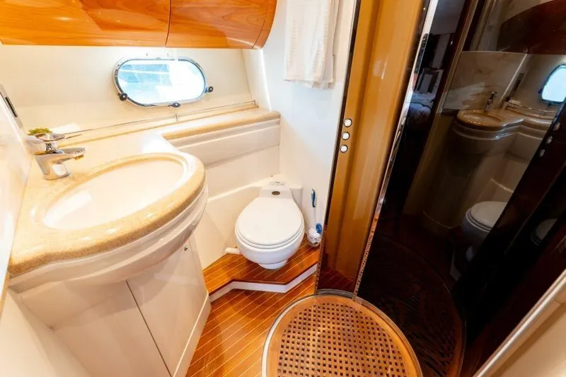 Jugni Yacht Photos Pics Luxurious bathroom in 2003 Viking Princess 65 yacht with wood accents and modern fixtures.