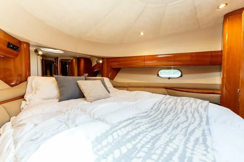 Jugni Yacht Photos Pics Luxurious bedroom interior of 2003 Viking Princess 65 yacht with elegant wood finishes.