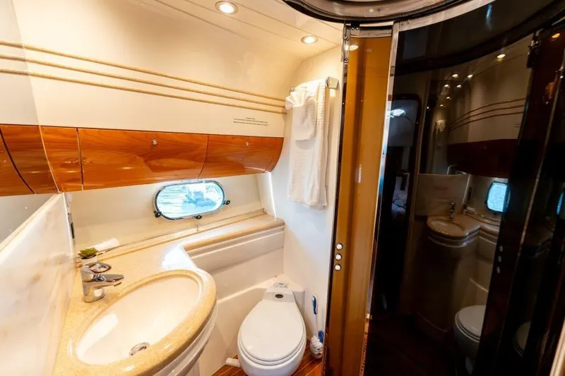 Jugni Yacht Photos Pics Luxurious bathroom in 2003 Viking Princess 65 yacht with elegant wood accents.