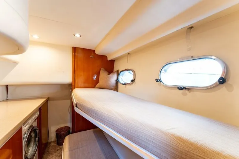 Jugni Yacht Photos Pics Cozy cabin interior of 2003 Viking Princess 65 yacht with bunk beds and porthole windows.