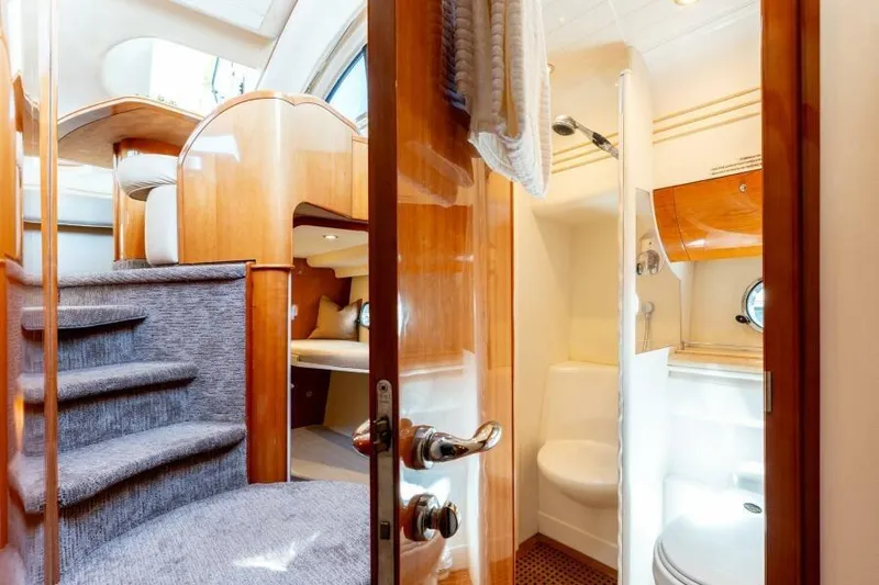 Jugni Yacht Photos Pics Luxurious 2003 Viking Princess 65 yacht interior with elegant wood finishes and cozy cabin.