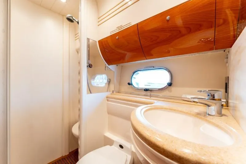 Jugni Yacht Photos Pics Luxurious bathroom in 2003 Viking Princess 65 yacht with elegant wood cabinetry.