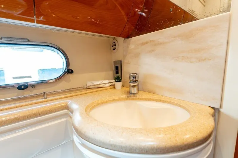 Jugni Yacht Photos Pics Luxurious bathroom sink in 2003 Viking Princess 65 yacht, featuring elegant design and modern fixtures.