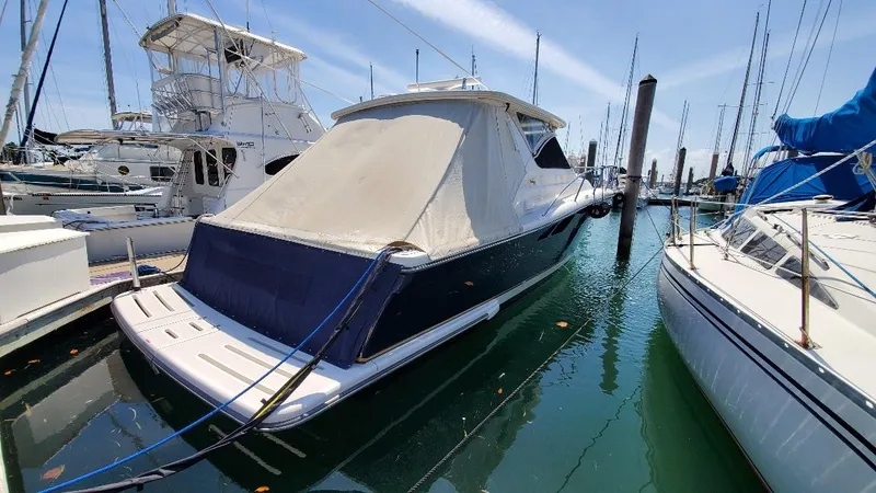 Blue Meridian Yacht Photos Pics 2003 Tiara Yachts 3800 Open docked in a marina, surrounded by other boats.