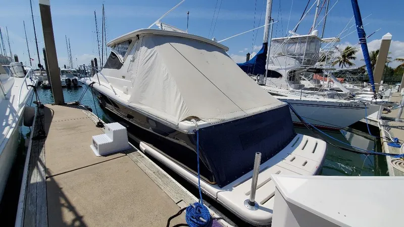 Blue Meridian Yacht Photos Pics 2003 Tiara Yachts 3800 Open docked at marina under clear blue sky.