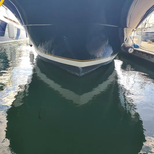 Blue Meridian Yacht Photos Pics 2003 Tiara Yachts 3800 Open docked, reflecting on calm water.