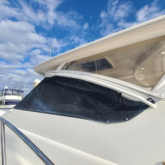 Blue Meridian Yacht Photos Pics 2003 Tiara Yachts 3800 Open with black window cover under a blue sky.