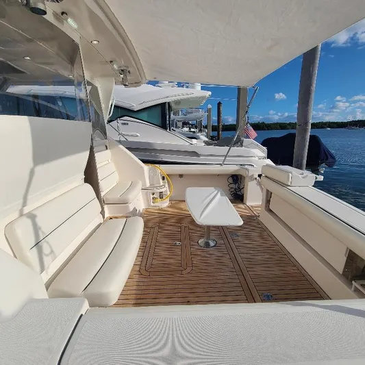 Blue Meridian Yacht Photos Pics 2003 Tiara Yachts 3800 Open with spacious deck, seating, and table, docked by the water.