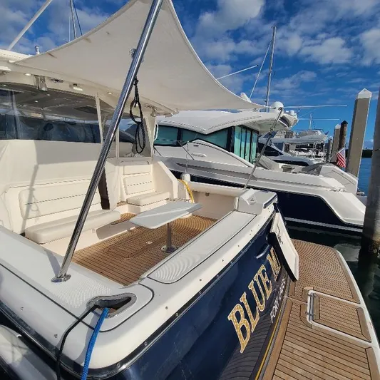 Blue Meridian Yacht Photos Pics 2003 Tiara Yachts 3800 Open docked, featuring spacious deck and seating area.