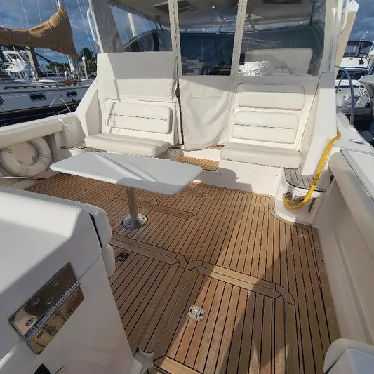 Blue Meridian Yacht Photos Pics 2003 Tiara Yachts 3800 Open with teak deck and white seating in a marina setting.