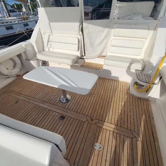Blue Meridian Yacht Photos Pics 2003 Tiara Yachts 3800 Open with teak deck and white seating area.