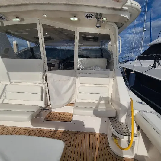 Blue Meridian Yacht Photos Pics 2003 Tiara Yachts 3800 Open, spacious deck with white seating and wooden flooring.