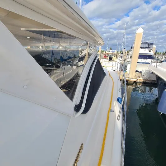 Blue Meridian Yacht Photos Pics 2003 Tiara Yachts 3800 Open docked at marina under cloudy sky.