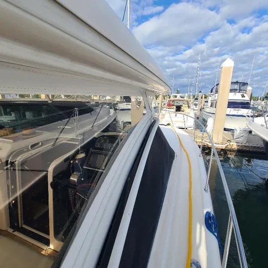 Blue Meridian Yacht Photos Pics 2003 Tiara Yachts 3800 Open docked at marina under blue sky.