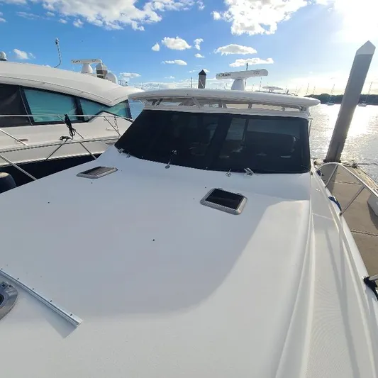 Blue Meridian Yacht Photos Pics 2003 Tiara Yachts 3800 Open docked under a clear blue sky.